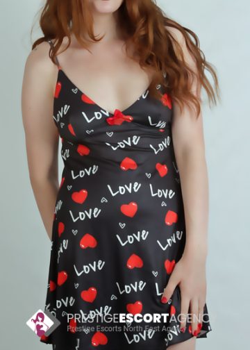 Woman in love-themed dress posing