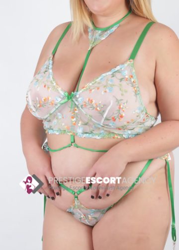 Woman posing in green floral lingerie