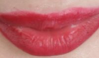 Close-up of red lips with lipstick.